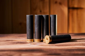 Muurstickers Hunting shells and 12 gauge cartridges on wooden background © Vitalii Makarov