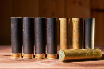 Tuinposter Hunting shells and 12 gauge cartridges on wooden background © Vitalii Makarov