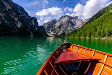Lake Braies (also known as Pragser Wildsee or Lago di Braies) in Dolomites Mountains, Sudtirol, Italy. Romantic place with typical wooden boats on the alpine lake.  Hiking travel and adventure.