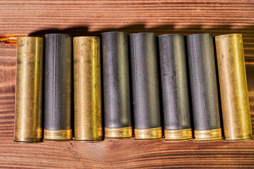 Hunting shells and 12 gauge cartridges on wooden background