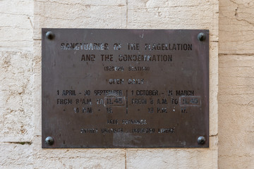 Board with hours of work attached at the entrance to Church of the Condemnation and Imposition of...