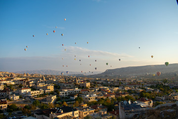 Aerial view on Sunrise over Cappadocia. Balloons flying against blue sky. Goreme most popular place in Turkey 