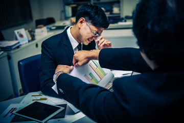 Two asian businessmen discuss about business of company,Two people are talking about work stress and more serious,Angry male furious boss scolding employee