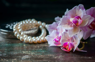 Pink orchid with a pearl necklace