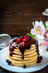 Pancakes with berries and chocolate sauce