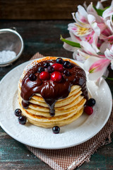 Pancakes with berries and chocolate sauce