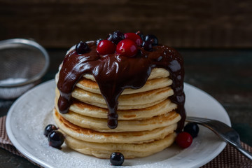 Pancakes with berries and chocolate sauce