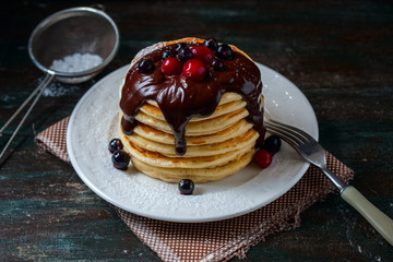 Pancakes with berries and chocolate sauce