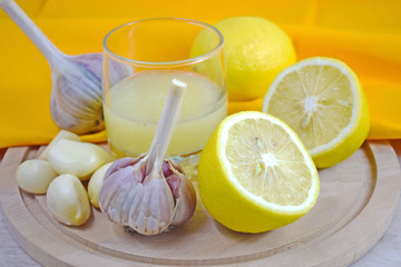 Healthy lemon drink and fresh garlic.