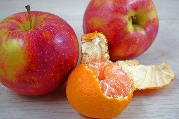 Healthy fruit.Delicious, juicy tangerine and red apples.