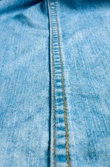 Blue washed faded jeans texture with seams