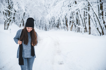 smiling woman portrait outdoors snow on hat winter season