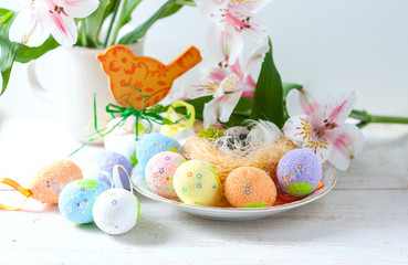 Easter eggs with spring flowers on table.