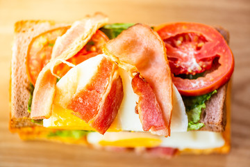 Club sandwich with egg, ham, tomato and vegetable, Top view.