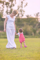 Fototapeta premium mother and little daughter playing at backyard