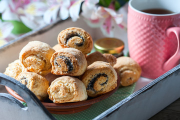 Homemade breakfast: rolls and cup of tea on vintage serving tray.