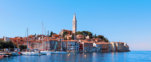 Fototapeta premium Beautiful and cozy medieval town of Rovinj, colorful with houses and a church in Croatia, in Europe. Panorama