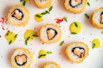 Sushi rolls scattered on white background