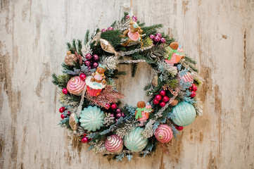 Christmas wreath decorated with pink and blue toy bulbs