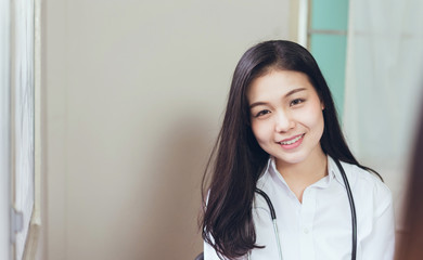 The women doctor and has stethoscope hanging on his neck.