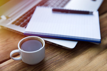 Notepad on keyboard with coffee