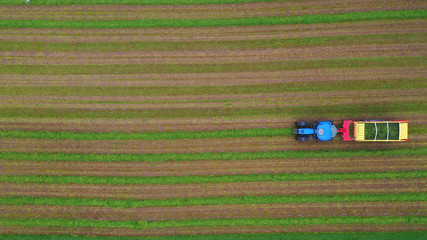 Fototapeta na wymiar Aerial top view of a tractor working in an arable agriculture farming field