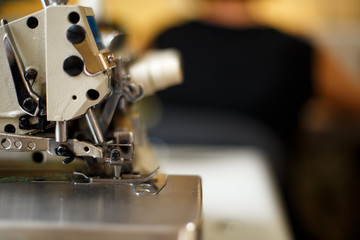 closeup details on sewing machine overlock. Workplace seamstress.Tailoring industry