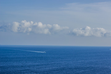 Naklejka na ściany i meble sea horizon landscape and small speed boat on water surface far from shot point 
