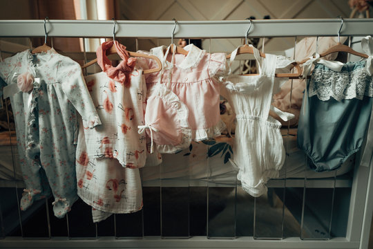 Baby clothing hung in a closet