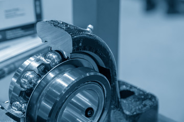 Cutaway part  of the metal ball  bearing in the light blue scene with lighting effect. Explore the...