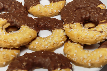 Sweet delicious ring-shaped chocolate chip cookies on a dish. White background.