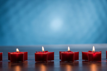Christmas burning candles on a blue background