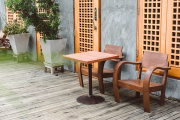 wooden chair in vintage house decoration with tree. Vintage loft decoration