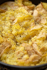 Background of smashed Yukon gold potatoes with rosemary seasoning	