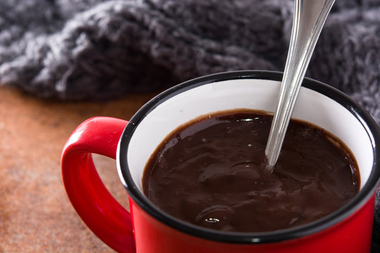Hot chocolate in mug on rusty background