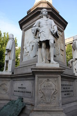 Monument to Leonardo Da Vinci with details around his statue on Piazza Della Scala in Milan, Italy.