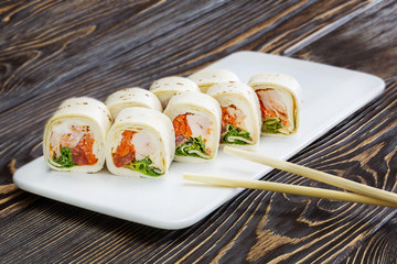 Japanese rolls, sushi on wooden background