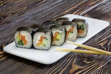 Japanese rolls, sushi on wooden background