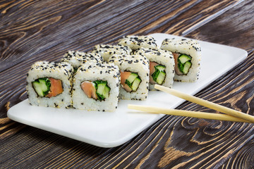 Japanese rolls, sushi on wooden background