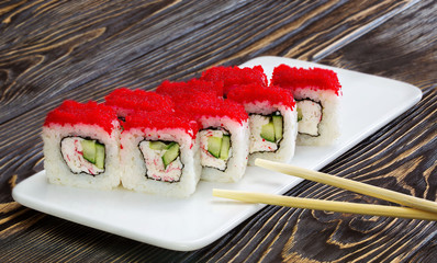 Japanese rolls, sushi on wooden background