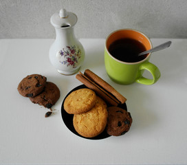  Cup and pot of coffee and coffee beans, cookies with cinnamon, isolated on white.