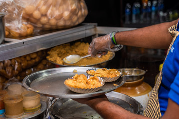 Street vendor making Indian sev puri  and pao baji 