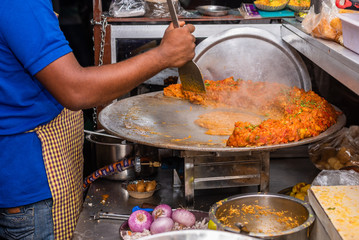 Street vendor making Indian sev puri  and pao baji 