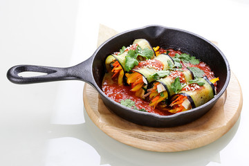 Eggplant rolls stuffed with tofu in a pan