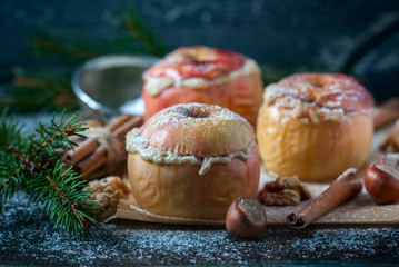 Baked apples with curd, honey and nuts  in the oven, closeup