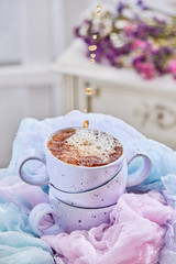 Stack of blue tea cups with dynamic splashes and tea drops on a light background. Action food photography. Delicate composition in a nice color with flowers and tea. homemade tea. close up