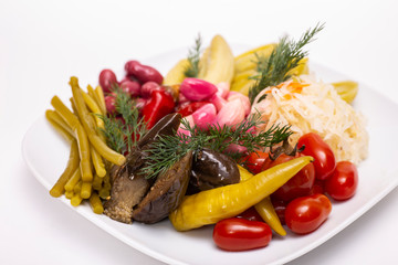 Pickles in assortment on a plate. Restaurant dish.
