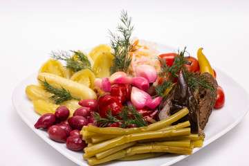 Pickles in assortment on a plate. Restaurant dish.
