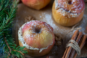 Baked apples with curd, honey and nuts  in the oven, closeup