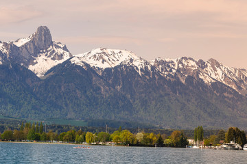 Stockhorn of Bernese Alps with lake Thun looking from street in village